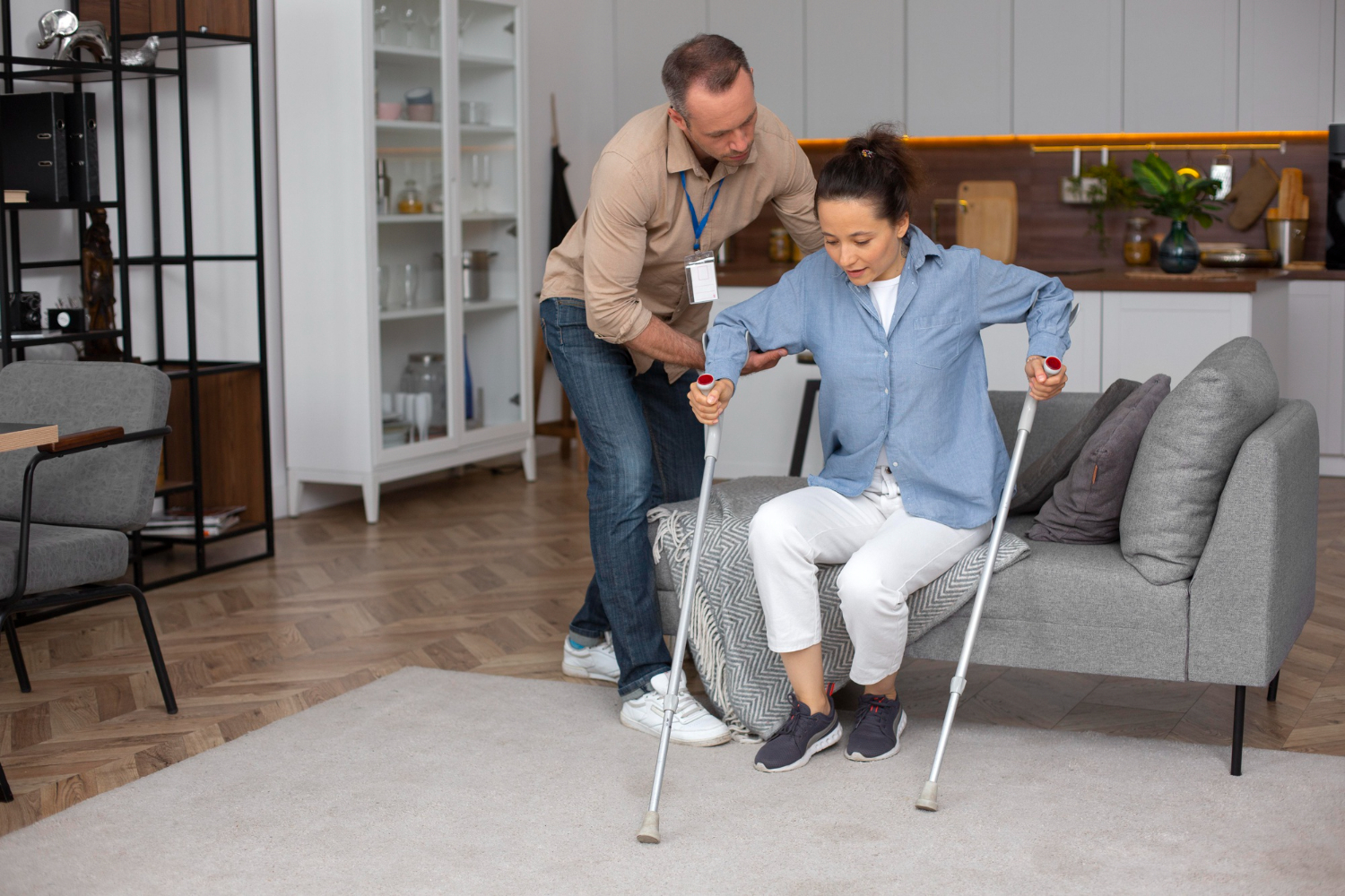 Patient assisted by healthcare professional with crutches, highlighting the importance of finding the right pain management specialist covered by BlueCross BlueShield insurance.