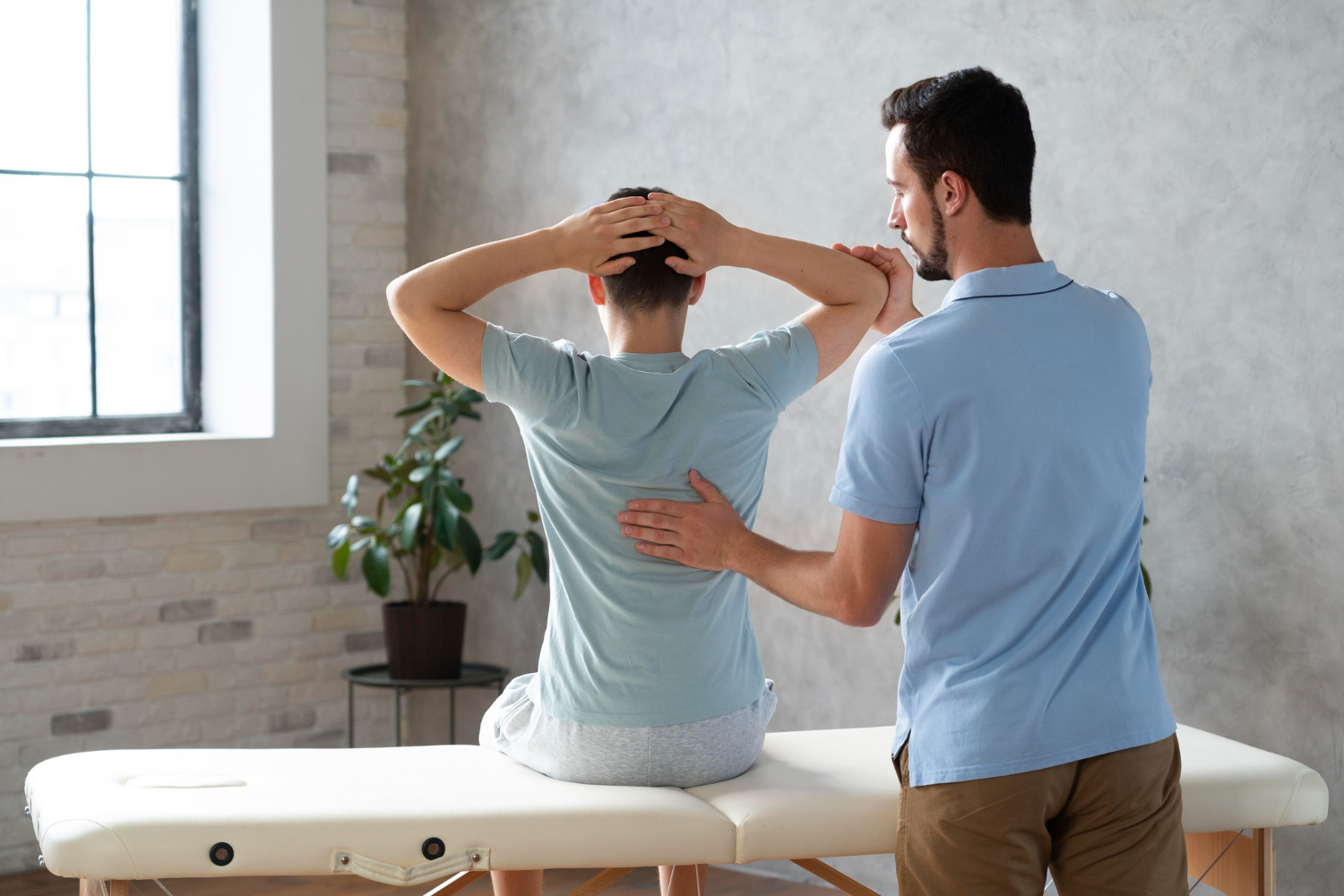 Chiropractor assisting patient with spine and back pain treatment in a chiropractic clinic. BlueCross BlueShield may cover certain back pain therapies.